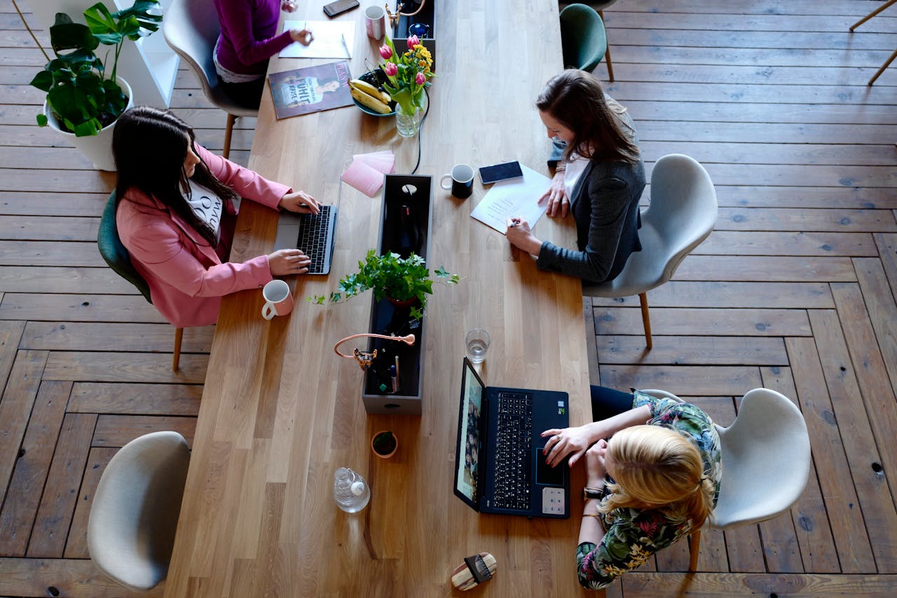 4 office women working at desk