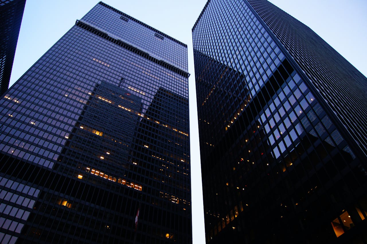 Two tall modern buildings reflecting on eachother